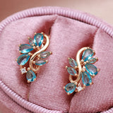 New Personality 14K Rose Gold Rolled Bright Blue AAA Zircon Crystals Hollow Charm Curve Symmetrical Buckle Earrings